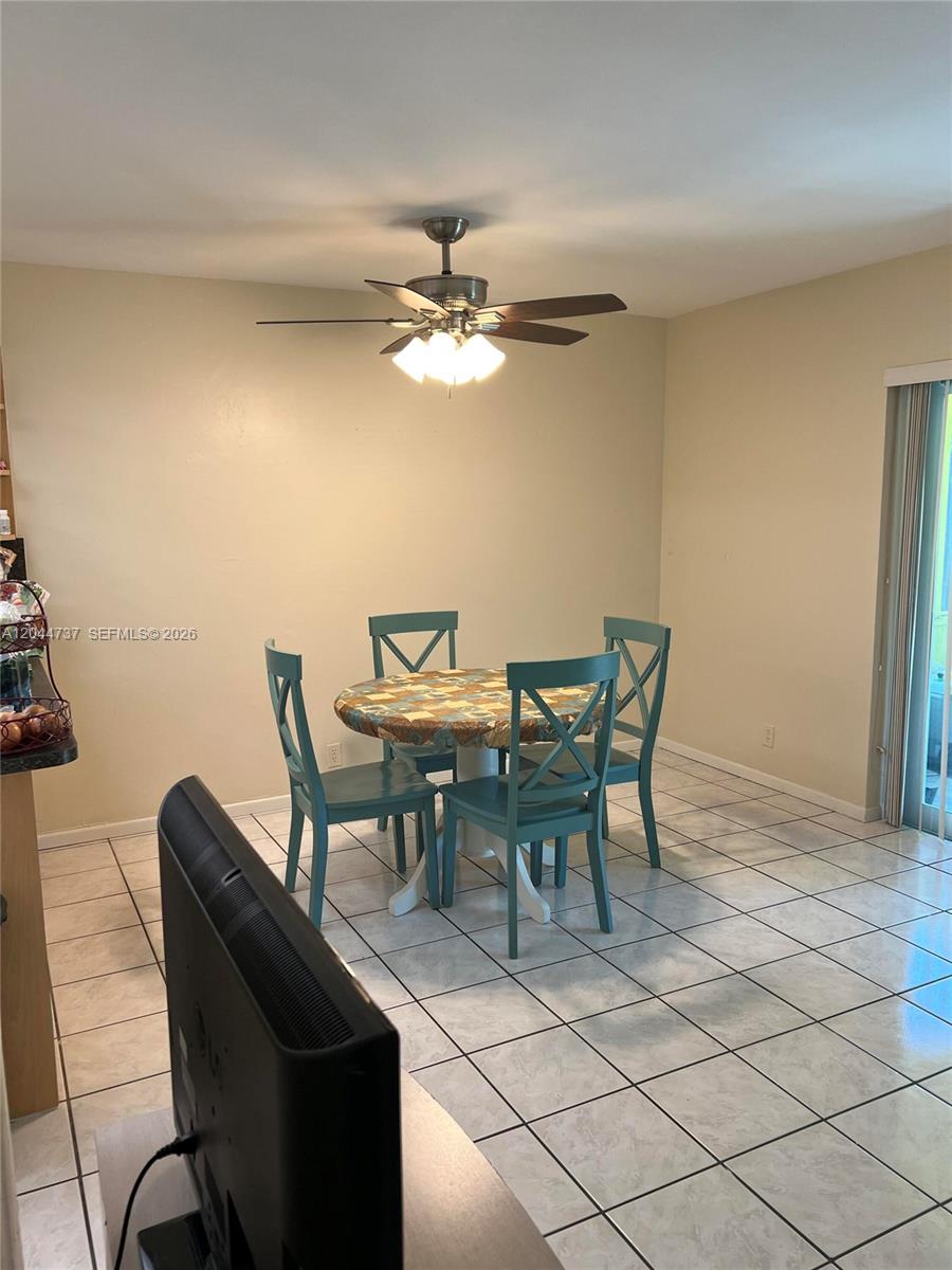 A dining area features a round table with four teal chairs and a ceiling fan — 3745 SW 59th Ave # 124, Davie FL 33314, DAVIE, FL