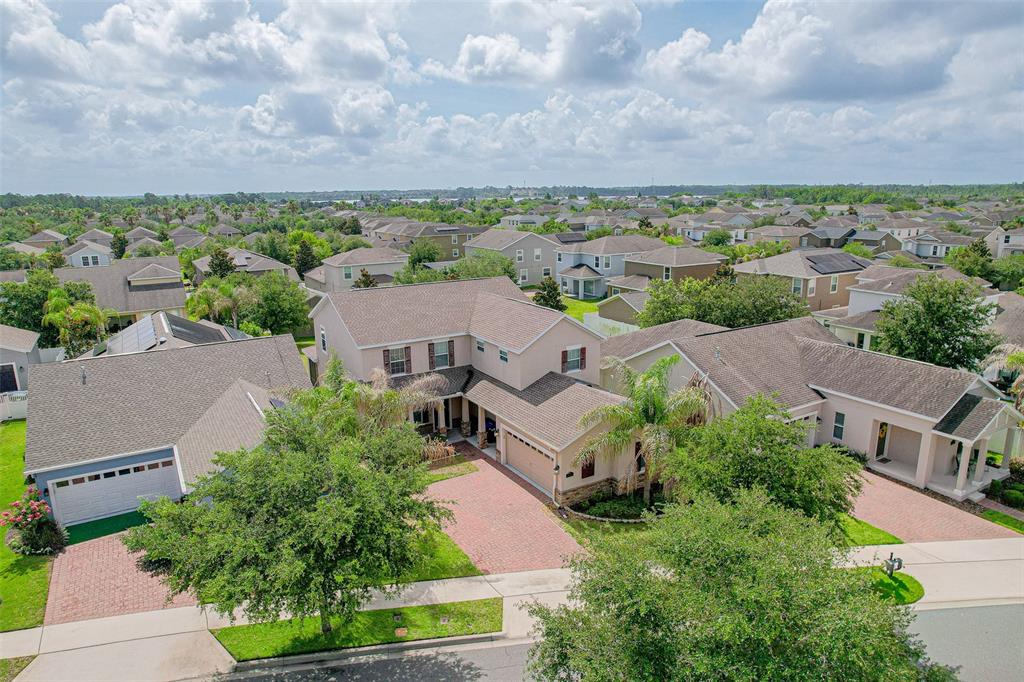 An aerial view shows a two-story suburban house with a brick driveway and shingled roof — 5973 CYPRESS HILL ROAD, WINTER GARDEN, FL