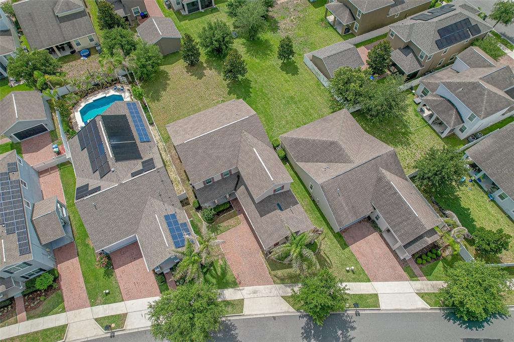 An aerial view shows three suburban houses with brick driveways and green lawns — 5973 CYPRESS HILL ROAD, WINTER GARDEN, FL