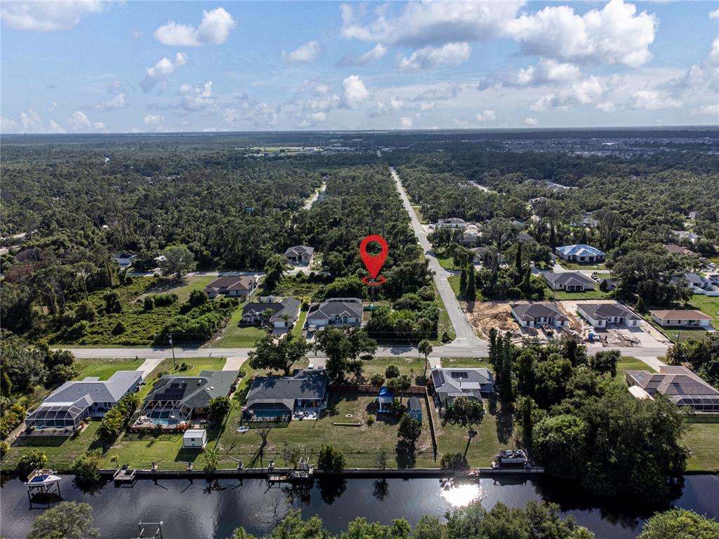 An aerial view shows a residential neighborhood with houses, a canal, and a red location pin — 17221 NIXON AVENUE, PORT CHARLOTTE, FL