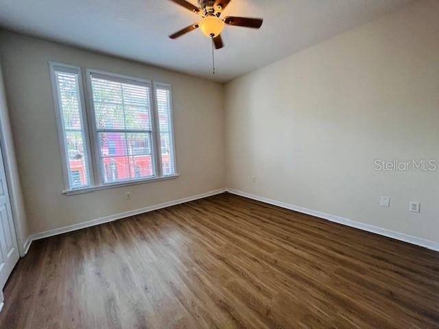An outdoor apartment corridor features orange walls, a gray floor, and a white railing — 606 MARKET STREET UNIT 230, CELEBRATION, FL