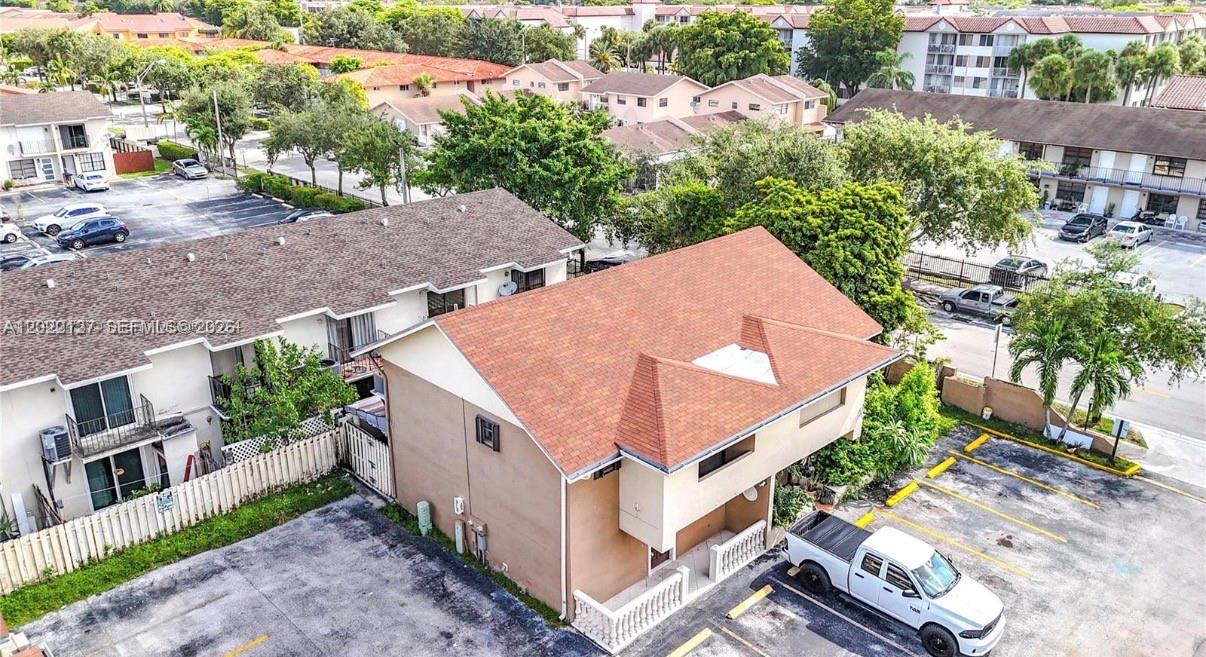 An aerial view shows a two-story residential building with a brown shingled roof and parking — 5350 W 26th Ave # 118, Hialeah FL 33016, HIALEAH, FL