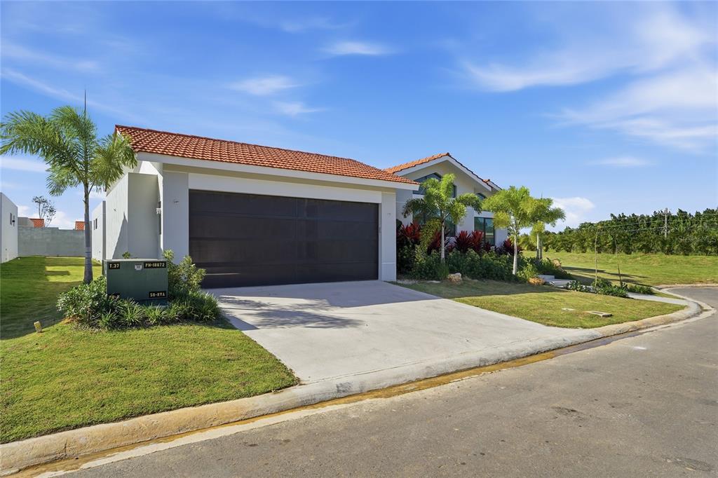 A single-story house with a terracotta tile roof and a two-car garage — 804 CAMINO DE LAS VERBENAS, DORADO, PR