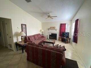 A living room features two red sofas, a fireplace, and a ceiling fan — 3739 59TH AVENUE W UNIT 3739, BRADENTON, FL