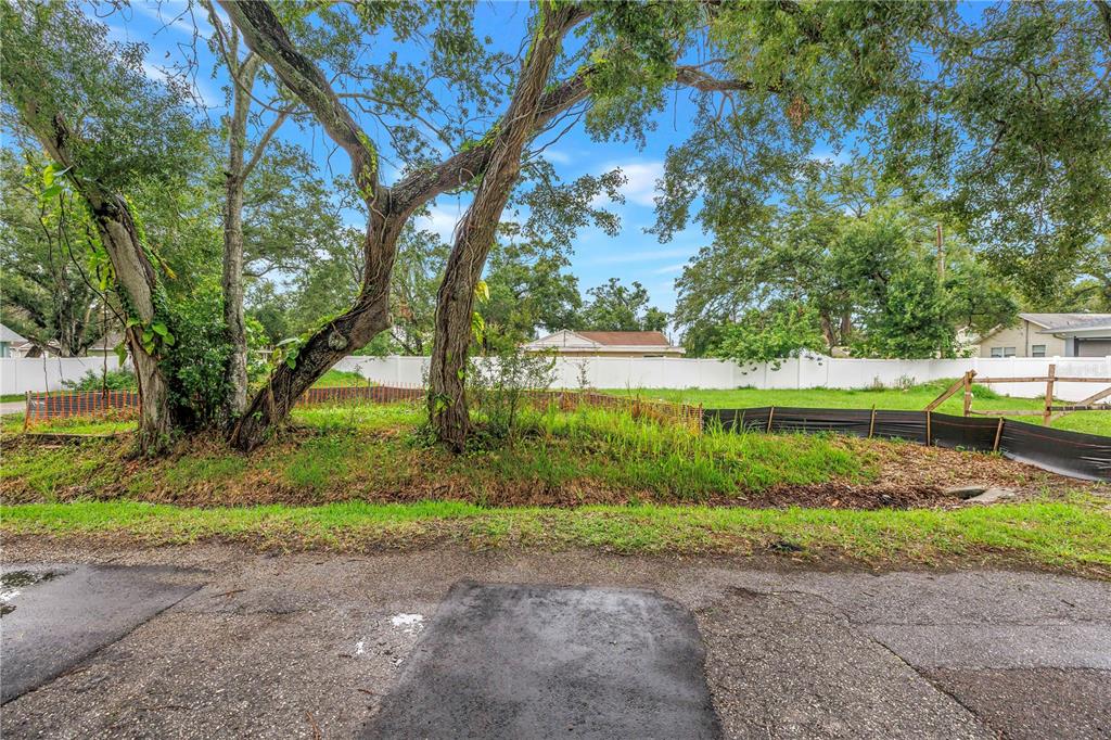 A vacant grassy lot with mature trees and a white vinyl fence in the background — 6401 29TH STREET N, ST PETERSBURG, FL