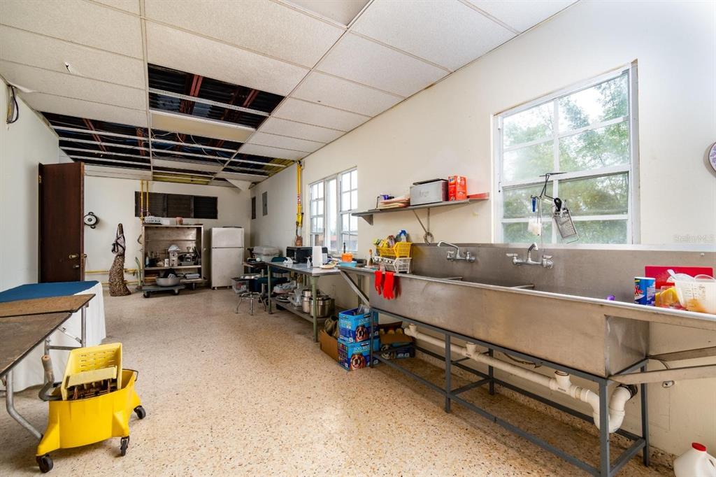 A commercial kitchen features a large stainless steel sink, a drop ceiling, and concrete floors — 734 BO ARENAS, CIDRA, PR