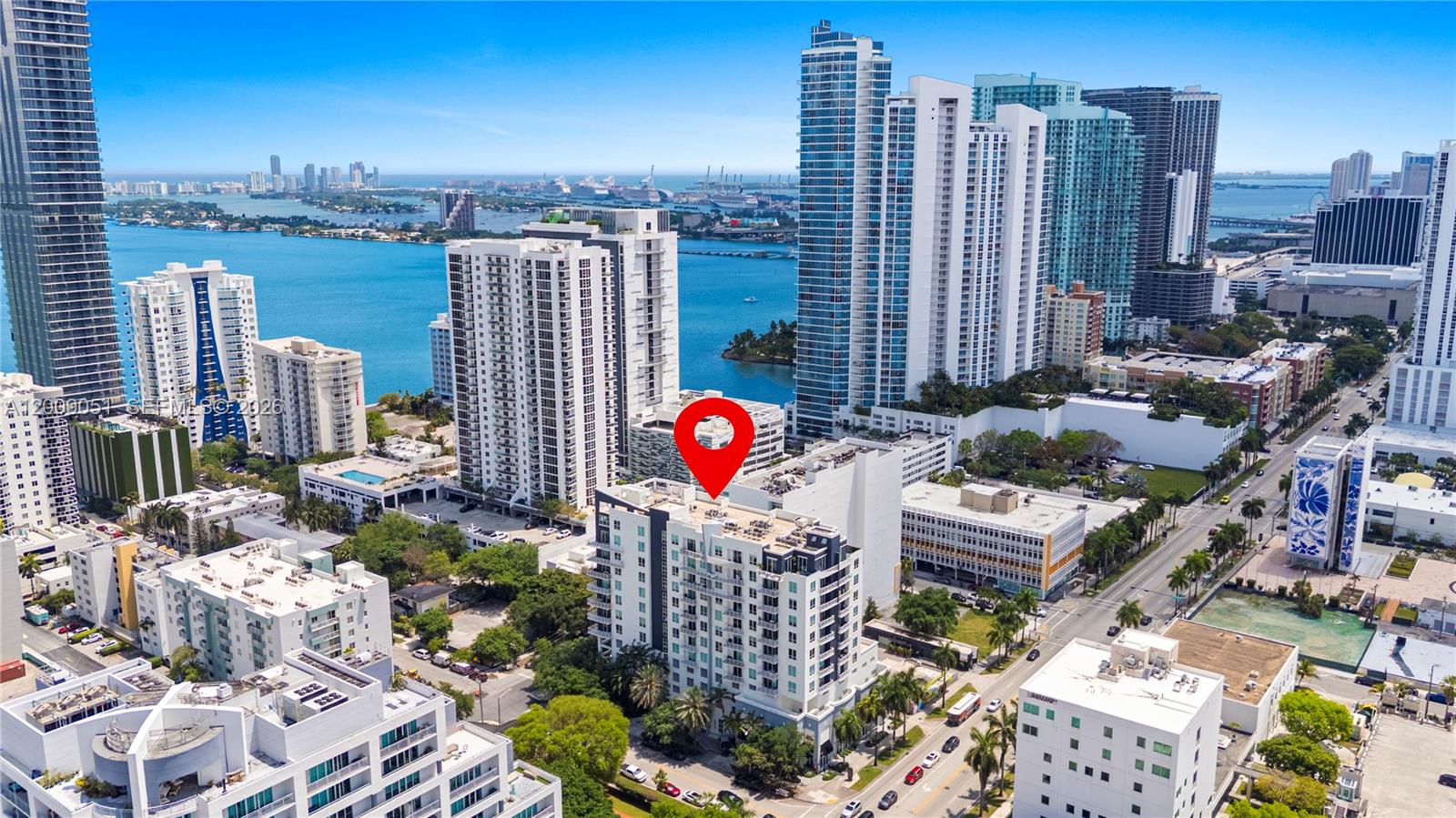 An aerial view of a city skyline featuring high-rise buildings and a red location marker — 2275 Biscayne Blvd # 802, Miami FL 33137, MIAMI, FL