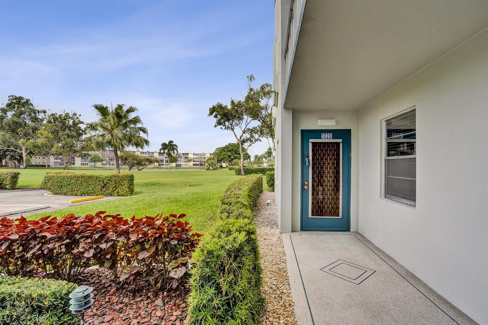 An exterior view shows a blue front door with a decorative screen to a residence — 1020 Lincoln, Boca Raton FL 33434, BOCA RATON, FL
