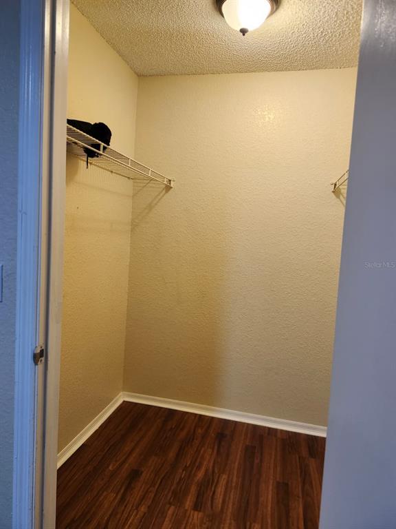 A kitchen features granite countertops, white cabinets, black appliances, and a tile floor — 2210 GRAND CAYMAN COURT UNIT 1721, KISSIMMEE, FL