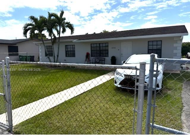 A single-story house with a white exterior, a brown roof, and a chain-link fence — 10752 SW 141st Ln, Miami FL 33176, MIAMI, FL