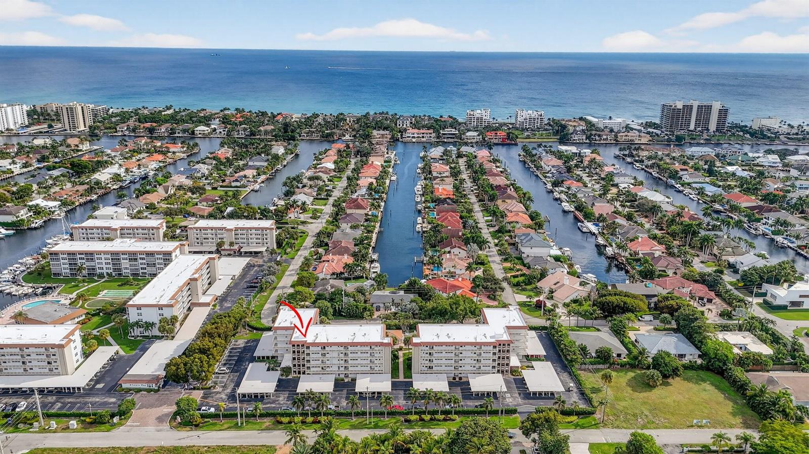 An aerial view shows a multi-story apartment complex with a red arrow pointing to it — 2809 Florida Boulevard # 208, Delray Beach FL 33483, DELRAY BEACH, FL