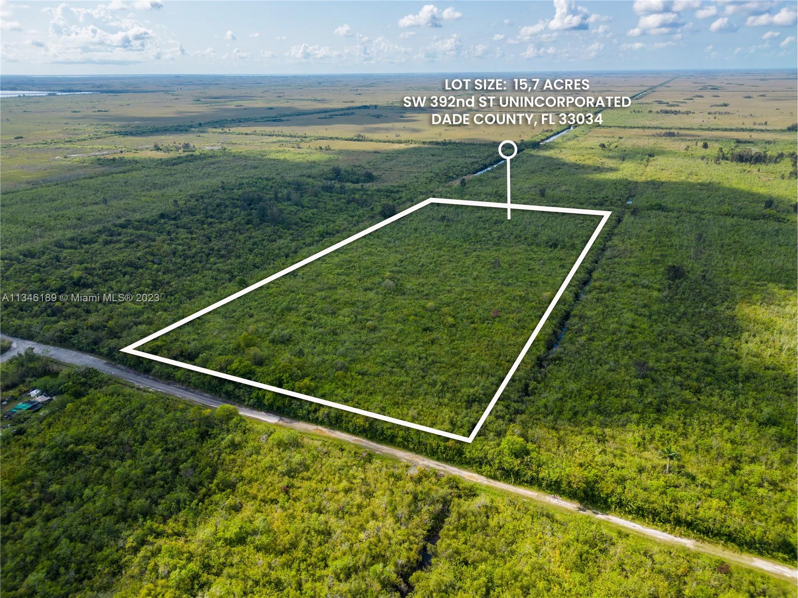 An aerial view shows a large, rectangular plot of undeveloped, wooded land — SW 392nd St, Unincorporated Dade County FL 33034, UNINCORPORATED DADE COUNTY, FL