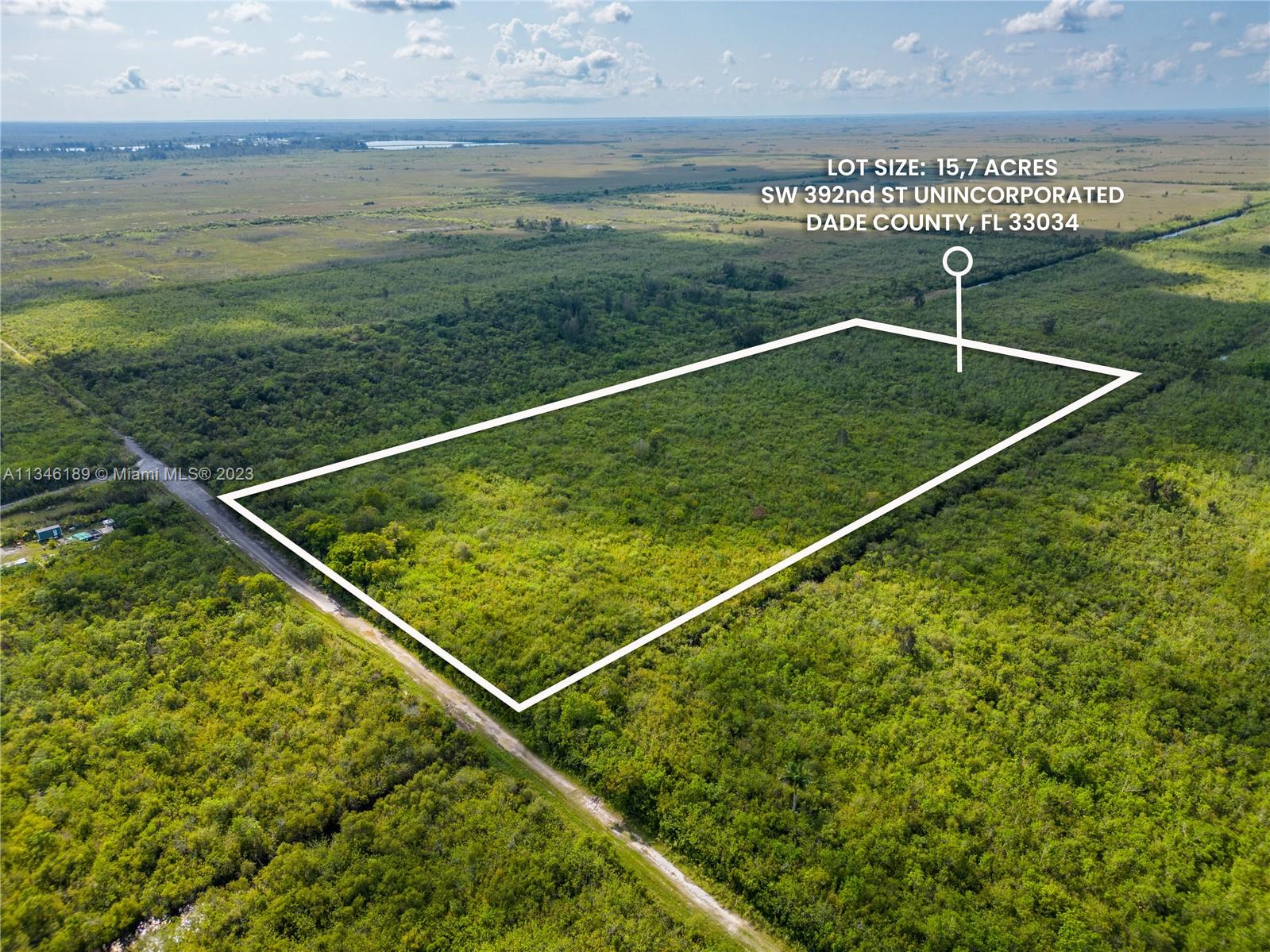 An aerial view shows a rectangular plot of undeveloped land outlined in white — SW 392nd St, Unincorporated Dade County FL 33034, UNINCORPORATED DADE COUNTY, FL