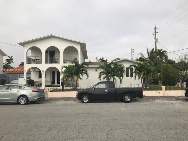 A two-story house with arched balconies and a black pickup truck parked in front — 1355 SW 12th St, Miami FL 33135, MIAMI, FL