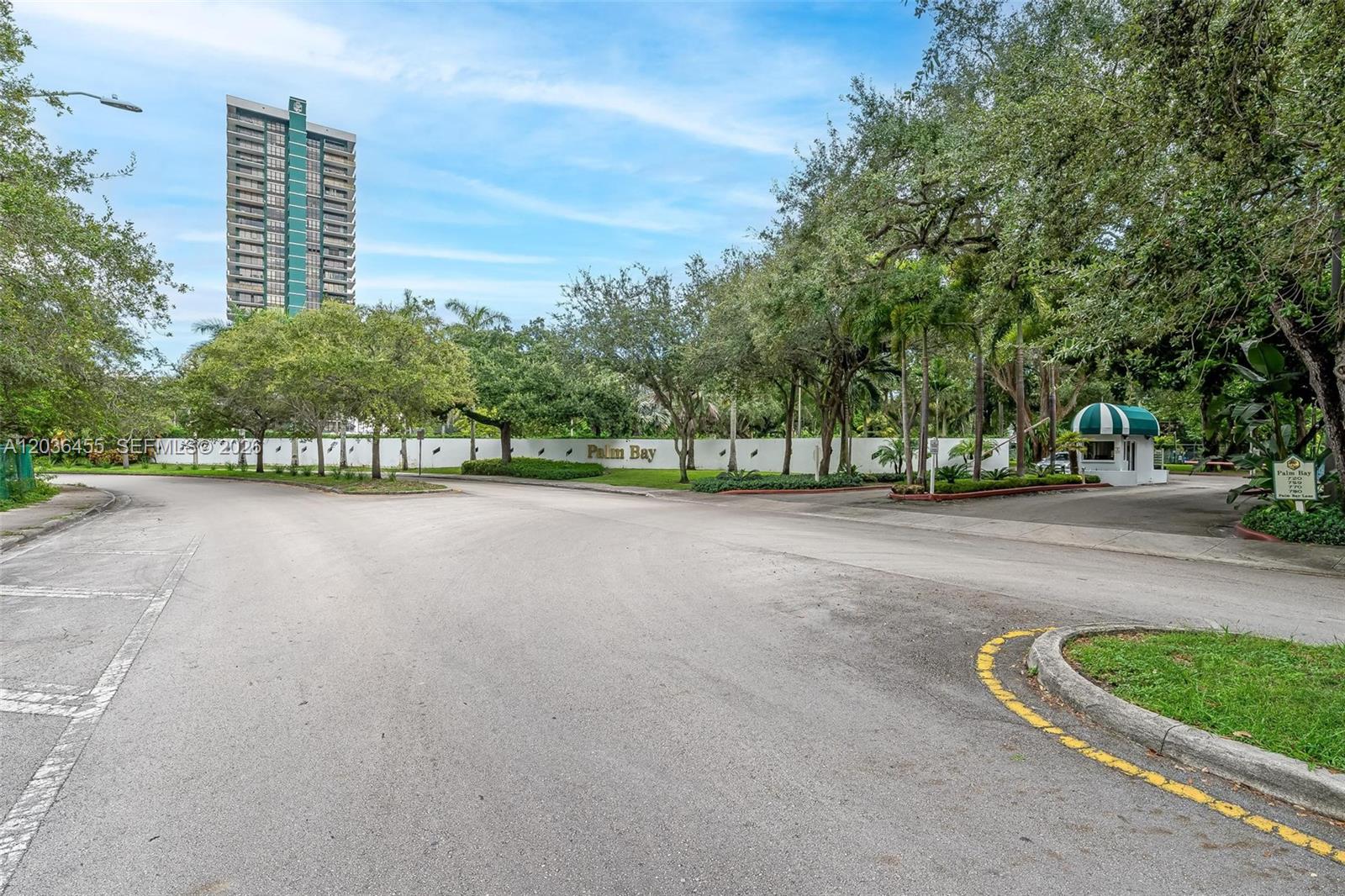 A gated entrance with a guardhouse and a tall residential building in the background — 780 NE 69th St # 1010, Miami FL 33138, MIAMI, FL