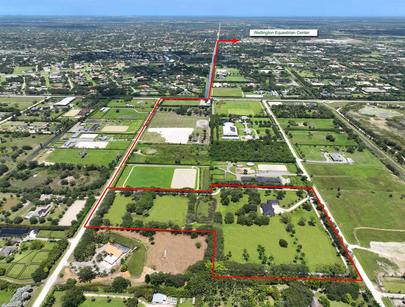 An aerial view shows a large, fenced equestrian property with multiple pastures and a residence — 16451 Norris Road, Wellington FL 33470, WELLINGTON, FL
