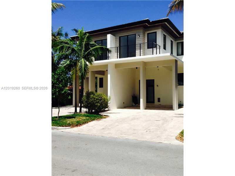 A two-story modern house features a covered ground-level parking area and a second-floor balcony — 472 FERNWOOD DR # 472, Key Biscayne FL 33149, KEY BISCAYNE, FL