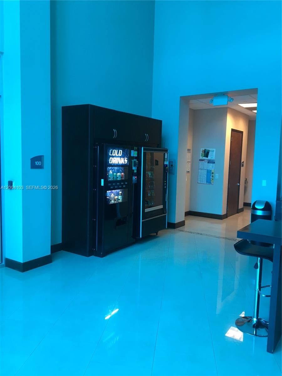 A room with a vending machine, a doorway, and a high-top table on tile flooring — 2300 W 84th St # 304, Hialeah FL 33016, HIALEAH, FL