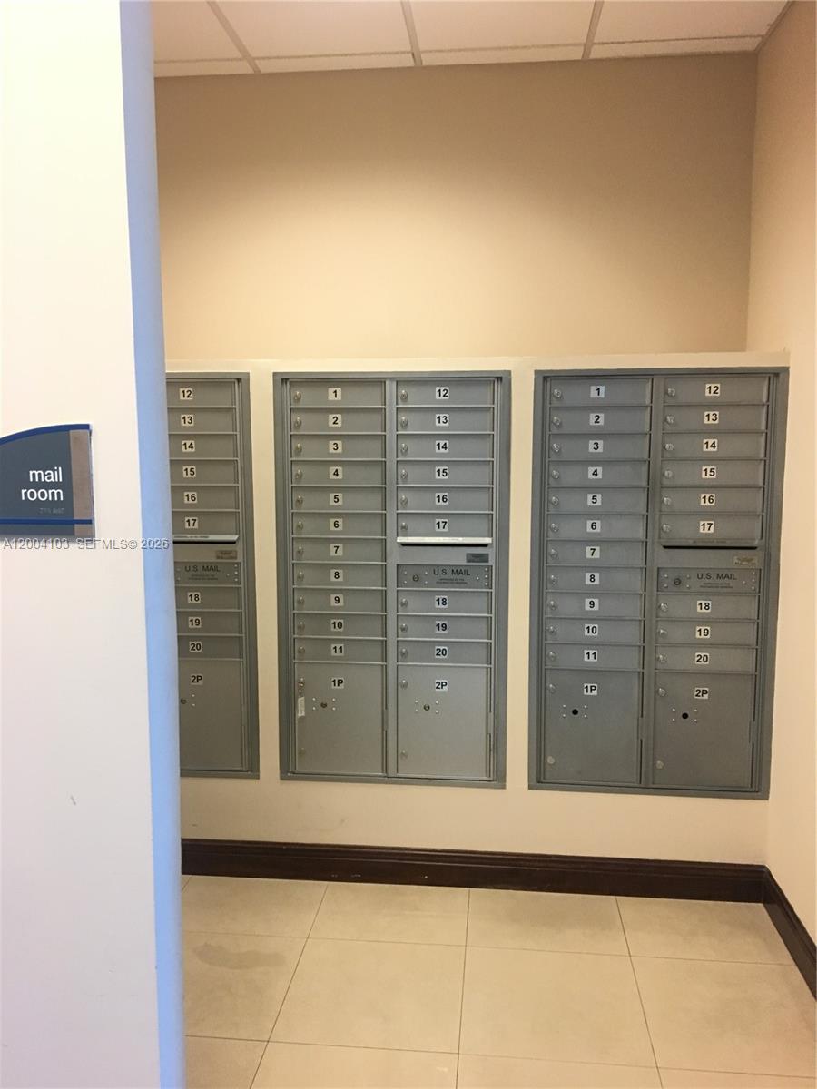 A mail room features three sets of gray metal wall-mounted mailboxes with numbered slots — 2300 W 84th St # 304, Hialeah FL 33016, HIALEAH, FL