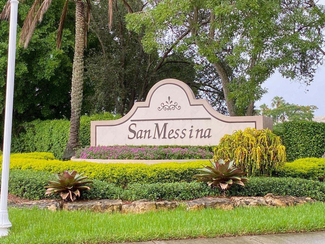 A stone sign for San Messina stands in a landscaped garden with shrubs and trees — 2253 Salerno Circle # 2253, Weston FL 33327, WESTON, FL