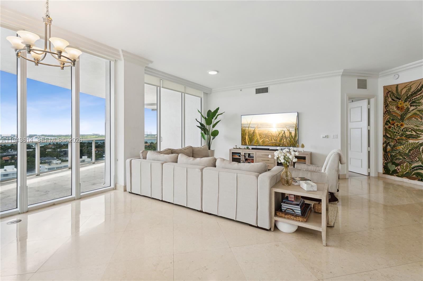 A living room features a large sectional sofa, a television, and floor-to-ceiling windows with views — 10225 Collins Ave # 904, Bal Harbour FL 33154, BAL HARBOUR, FL