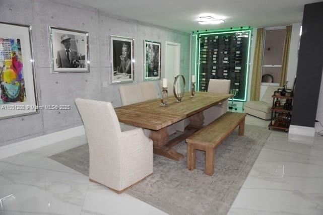 A dining room features a wooden table, a bench, upholstered chairs, and a glass wine display — 701 Brickell Key Blvd # 412, Miami FL 33131, MIAMI, FL