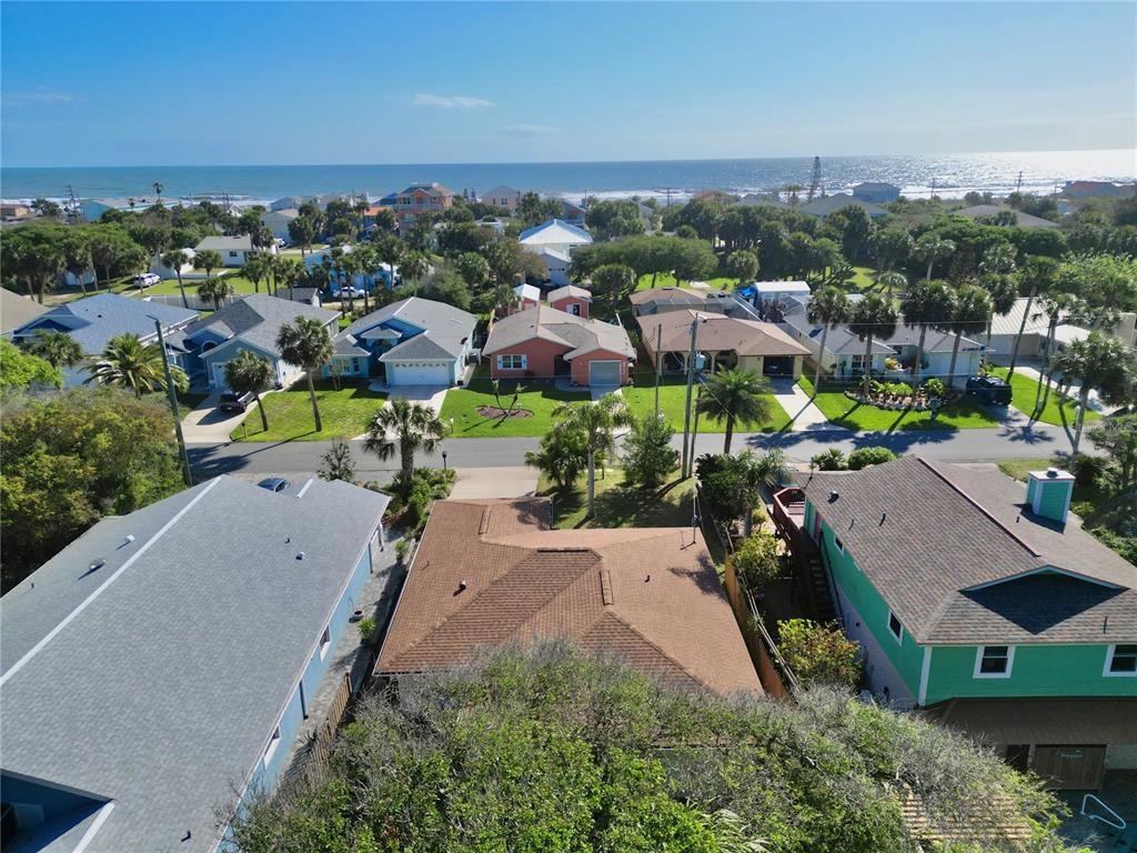 An aerial view shows a residential neighborhood with houses near the ocean — 1624 S DAYTONA AVENUE, FLAGLER BEACH, FL