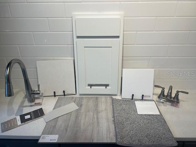 A display of interior design samples including cabinetry, flooring, countertops, and plumbing fixtures — 1774 CARNELIAN STREET, DELAND, FL