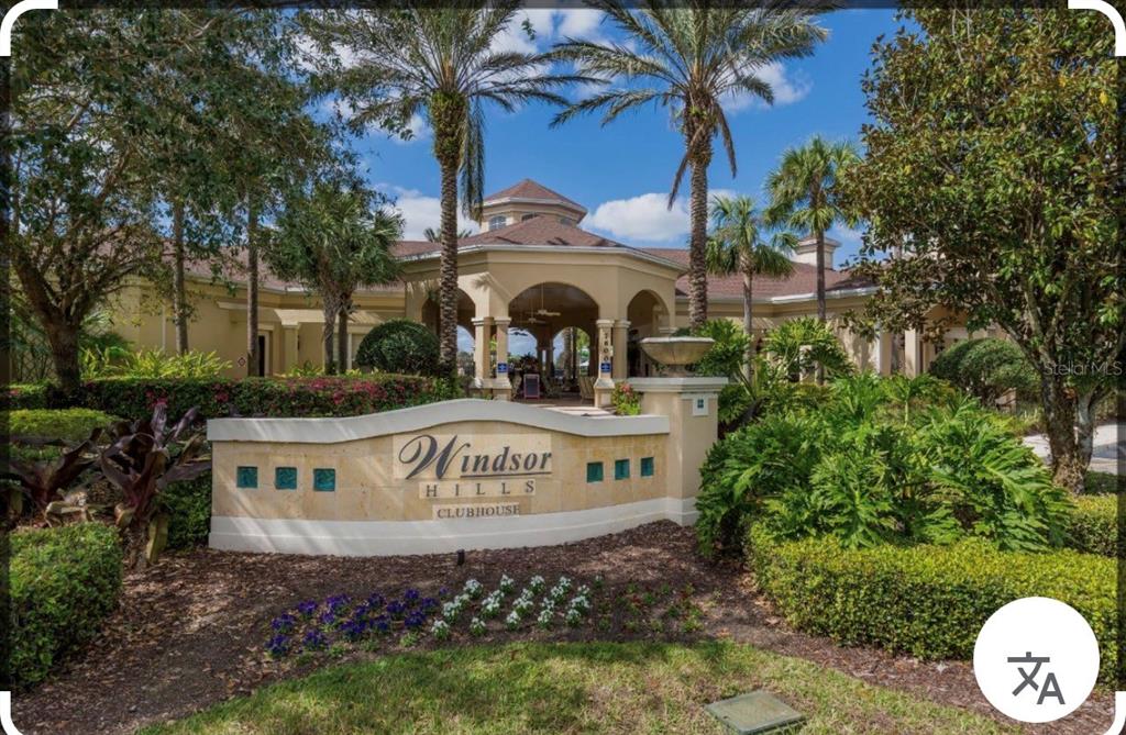The exterior of the Windsor Hills clubhouse features a beige building with a covered entrance — 2781 ALMATON LOOP UNIT 304, KISSIMMEE, FL