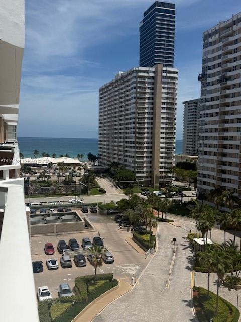 An elevated view shows a parking lot, palm trees, and high-rise buildings near the ocean — 1965 S Ocean Dr # 9K, Hallandale Beach FL 33009, HALLANDALE BEACH, FL