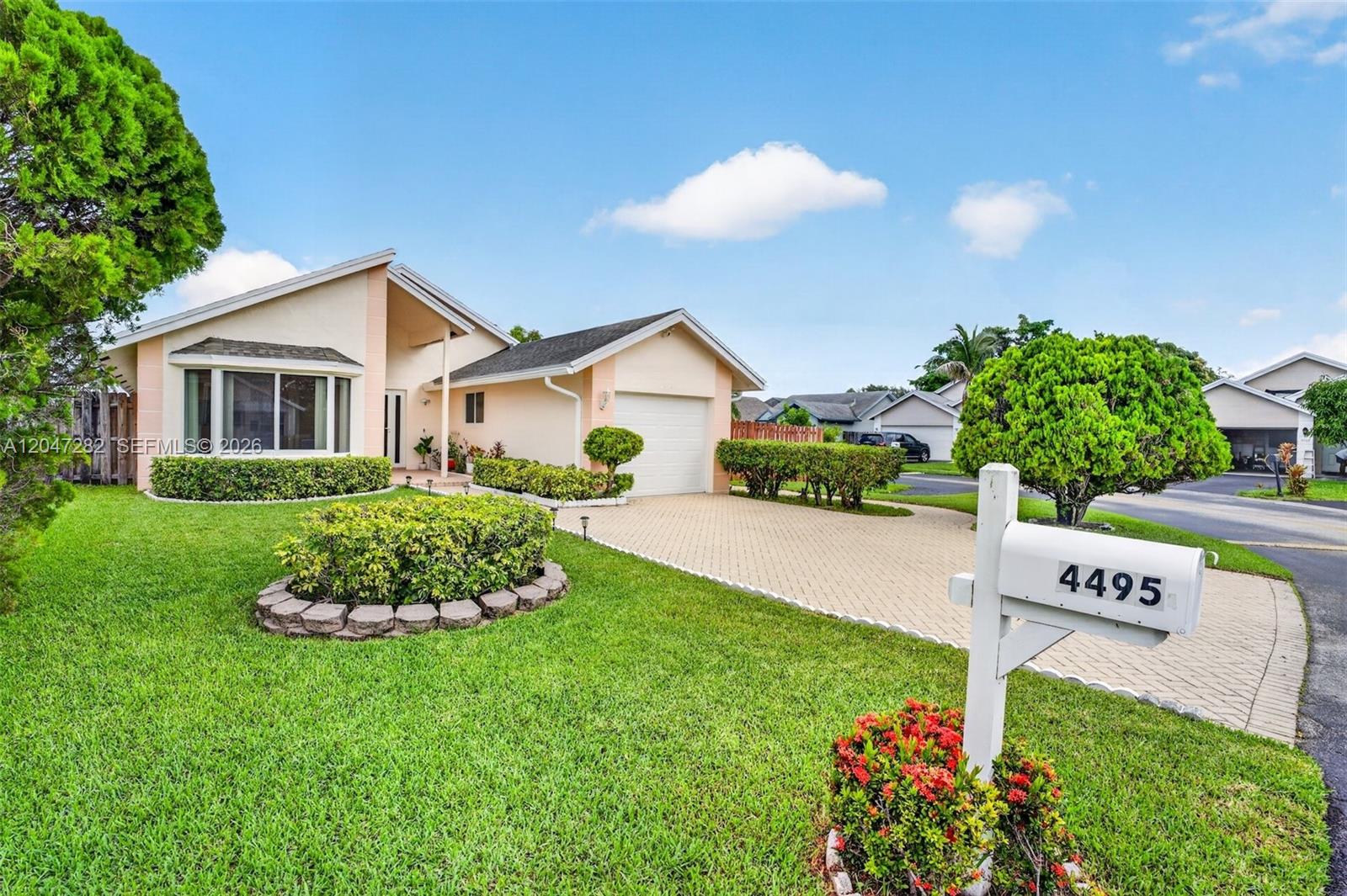 A single-story house with a paved driveway, a front lawn, and a white mailbox — 4495 NW 99th Ave, Sunrise FL 33351, SUNRISE, FL