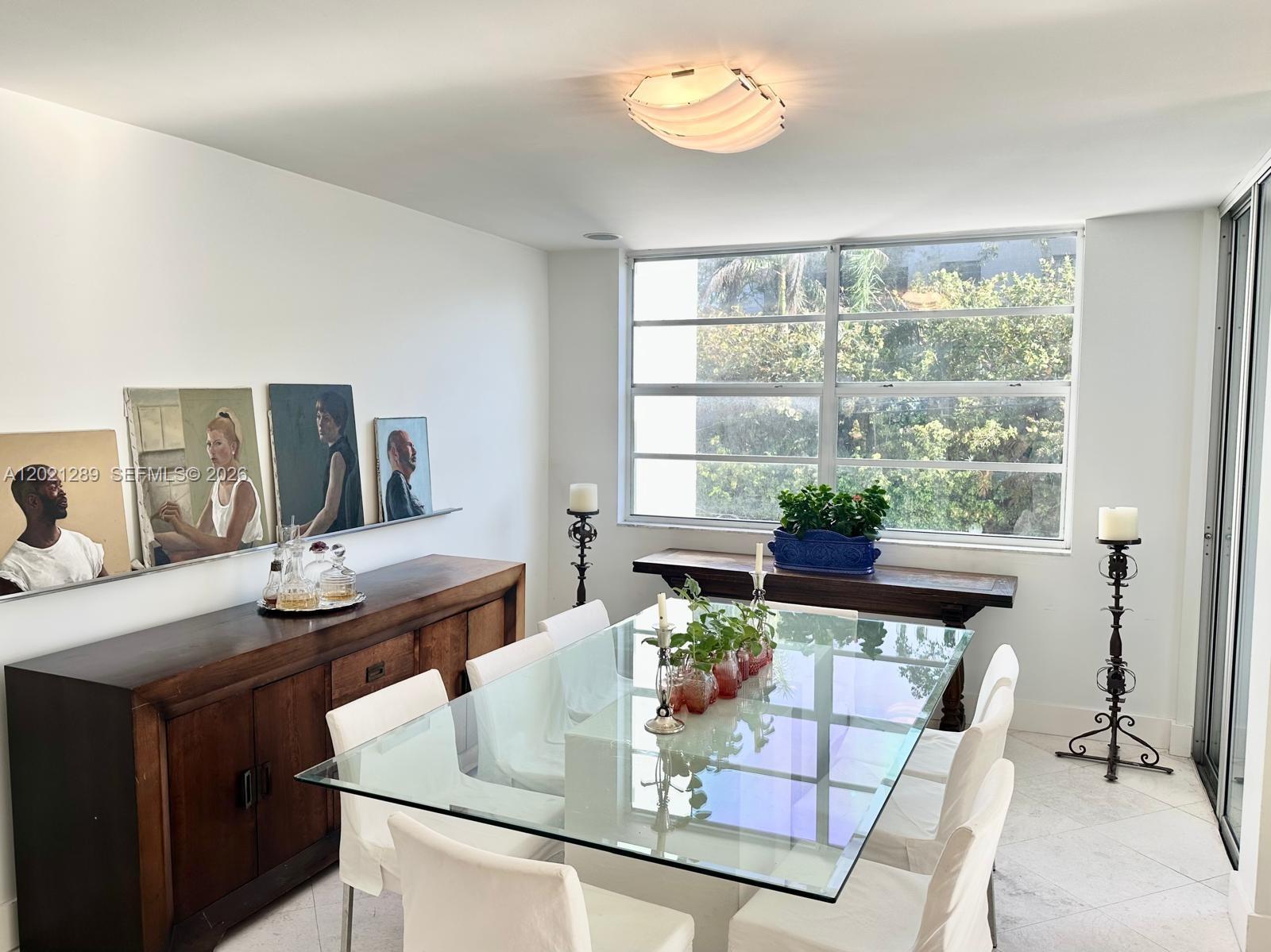 A dining room features a glass table, white chairs, a wooden sideboard, and large windows — 150 Ocean Lane Dr # 2A, Key Biscayne FL 33149, KEY BISCAYNE, FL