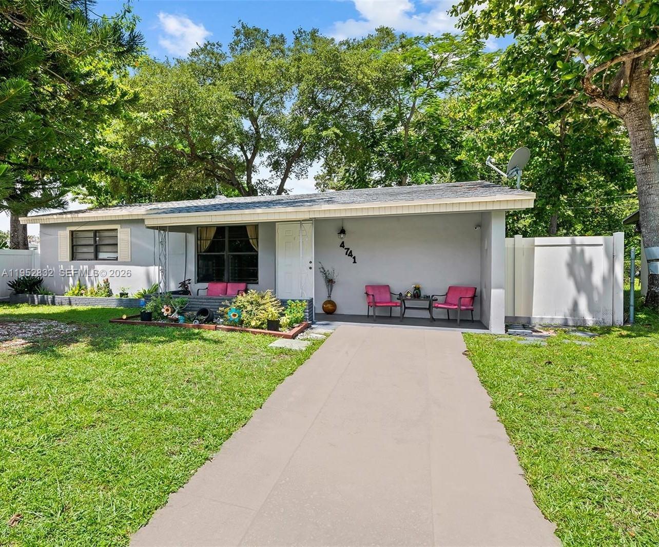 A single-story house with a gray exterior, a covered front porch, and a concrete driveway — 4741 SW 25th Ter, Dania Beach FL 33312, DANIA BEACH, FL