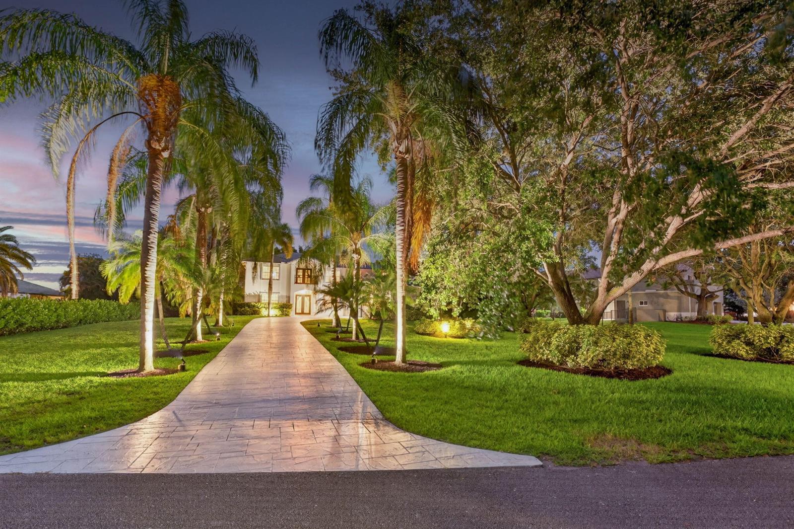 A paved driveway leads to a two-story house surrounded by palm trees and manicured lawns — 8346 Sawpine Road, Delray Beach FL 33446, DELRAY BEACH, FL