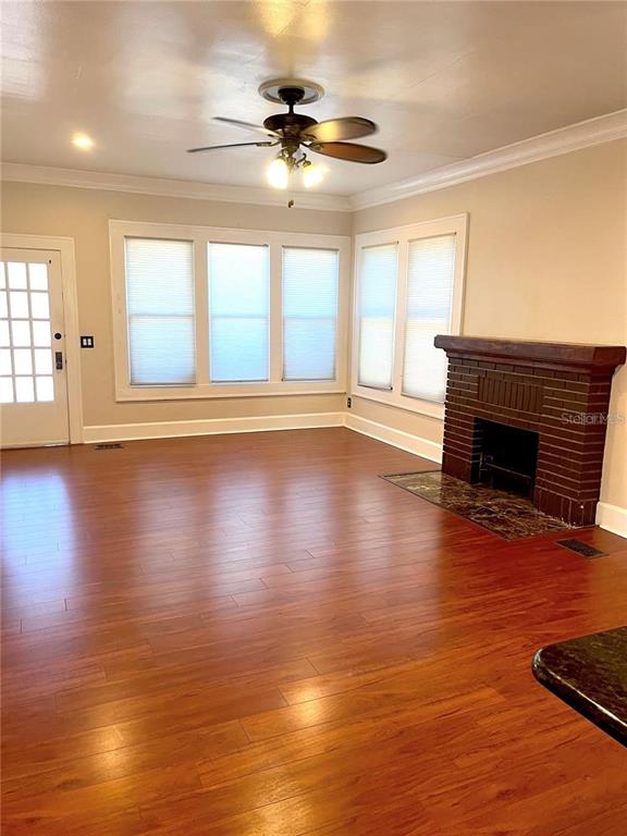 A living room features hardwood floors, a brick fireplace, and a ceiling fan — 2926 2ND AVENUE N Apt B, ST PETERSBURG, FL