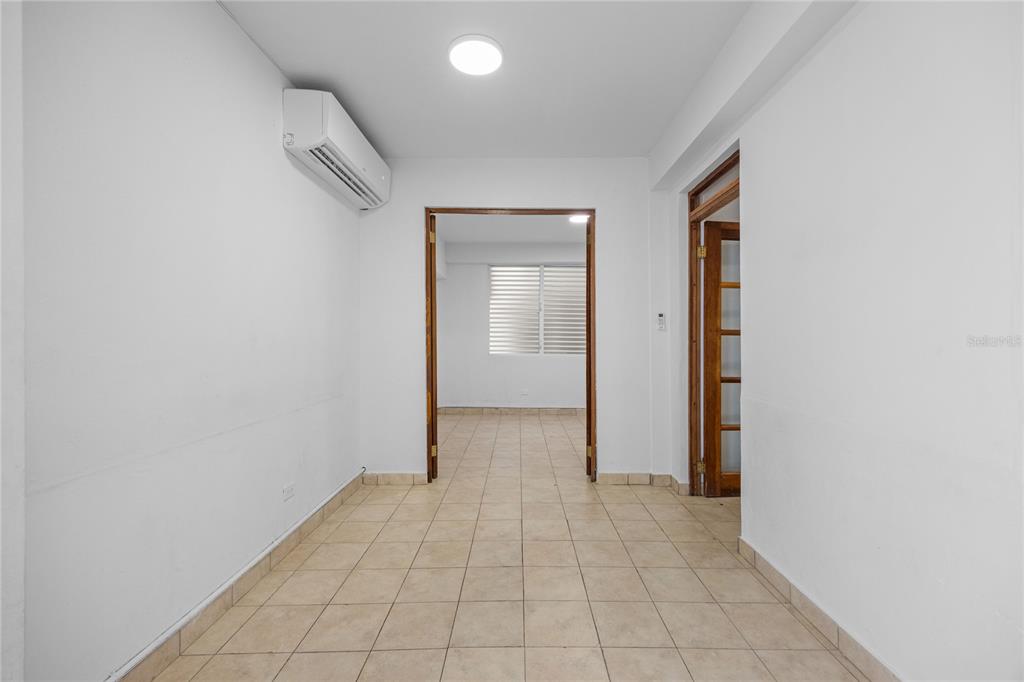 An interior view shows a tiled room leading through a doorway into another space — CAPARRA HEIGHTS J-42 ESCORIAL AVENUE UNIT 603, SAN JUAN, PR