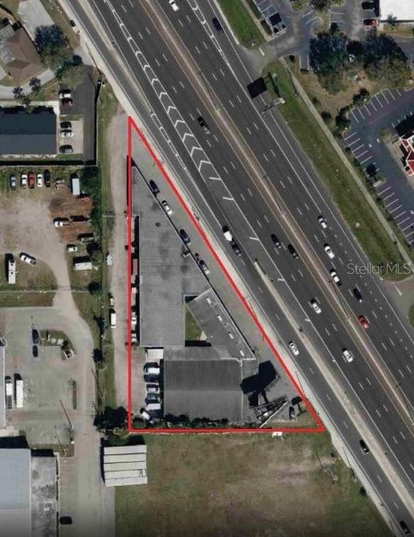 An aerial view shows a triangular commercial property outlined in red next to a highway — 10300 US HIGHWAY 19 N, PINELLAS PARK, FL