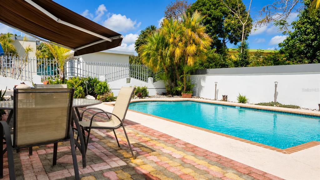 A patio with outdoor furniture overlooks a swimming pool in a fenced backyard — PR-651 KM 3.2. SR 651, ARECIBO, PR