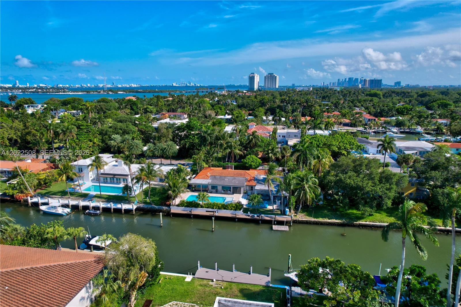 An aerial view shows waterfront homes with swimming pools and docks along a canal — 1141 NE 90th St, Miami FL 33138, MIAMI, FL