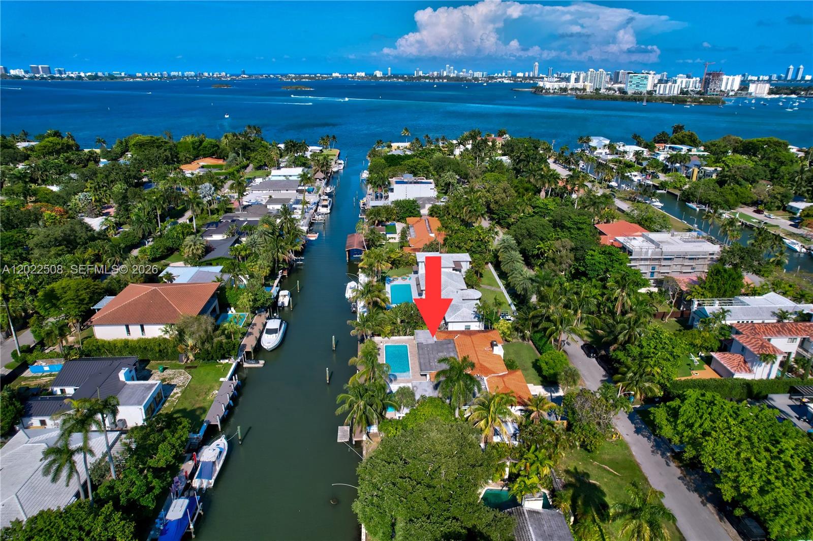 An aerial view shows a waterfront house with a swimming pool along a canal — 1141 NE 90th St, Miami FL 33138, MIAMI, FL