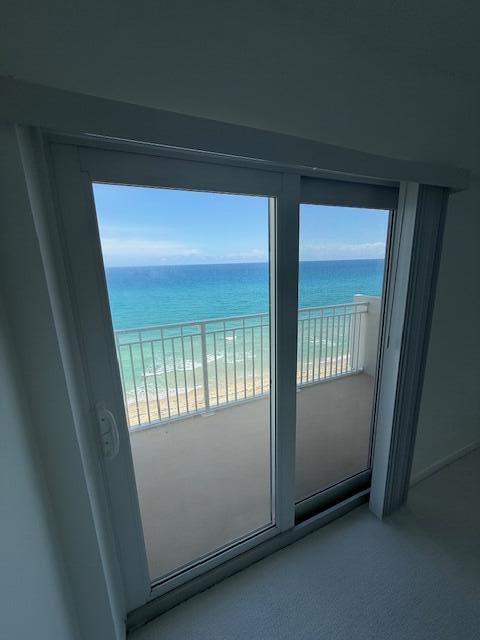 A sliding glass door opens to a balcony overlooking the ocean — 3215 S Ocean Boulevard # 911, Highland Beach FL 33487, HIGHLAND BEACH, FL