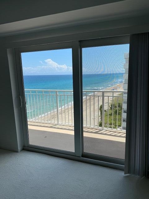 A view of the ocean and beach from a room with sliding glass doors — 3215 S Ocean Boulevard # 911, Highland Beach FL 33487, HIGHLAND BEACH, FL