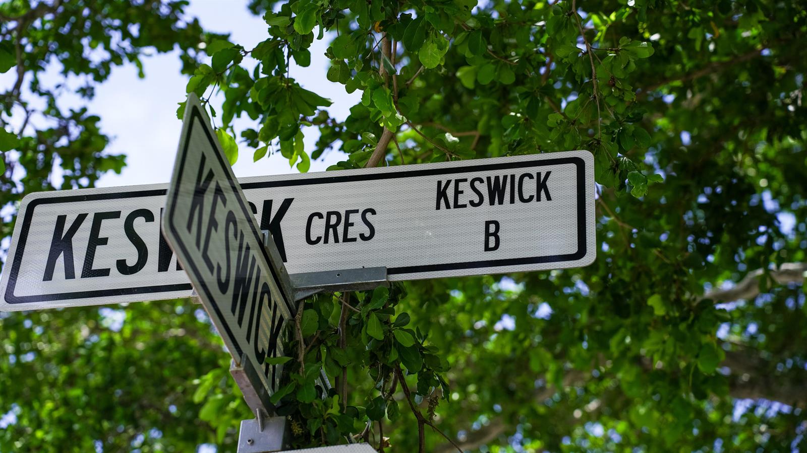 A street sign labeled Keswick Cres is mounted on a pole beneath green tree leaves — 38 Keswick # B, Deerfield Beach FL 33442, DEERFIELD BEACH, FL