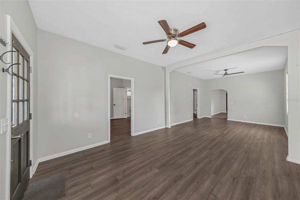 An interior view of a living area with light gray walls and dark wood flooring — 2613 N 21ST STREET, TAMPA, FL