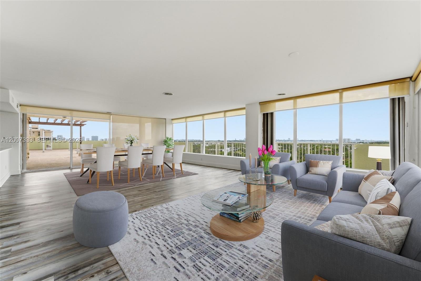A spacious living and dining area features floor-to-ceiling windows, light wood flooring, and a balcony — 2000 NE 135th St PH, North Miami FL 33181, NORTH MIAMI, FL