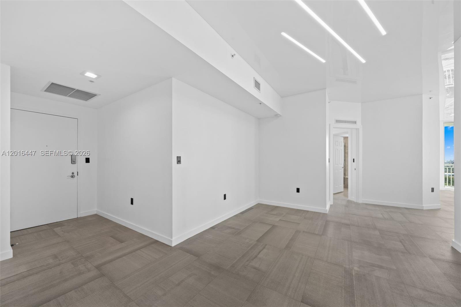 A minimalist room features white walls, gray tiled flooring, and recessed ceiling lighting — 1745 E Hallandale Beach Blvd PH, Hallandale Beach FL 33009, HALLANDALE BEACH, FL