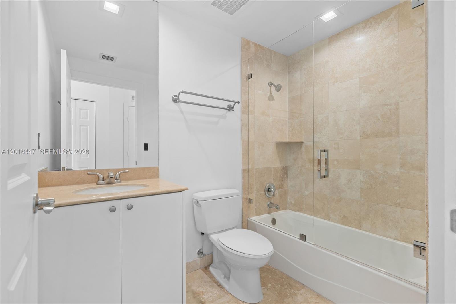 A bathroom features a vanity with a beige countertop, a toilet, and a tiled shower — 1745 E Hallandale Beach Blvd PH, Hallandale Beach FL 33009, HALLANDALE BEACH, FL