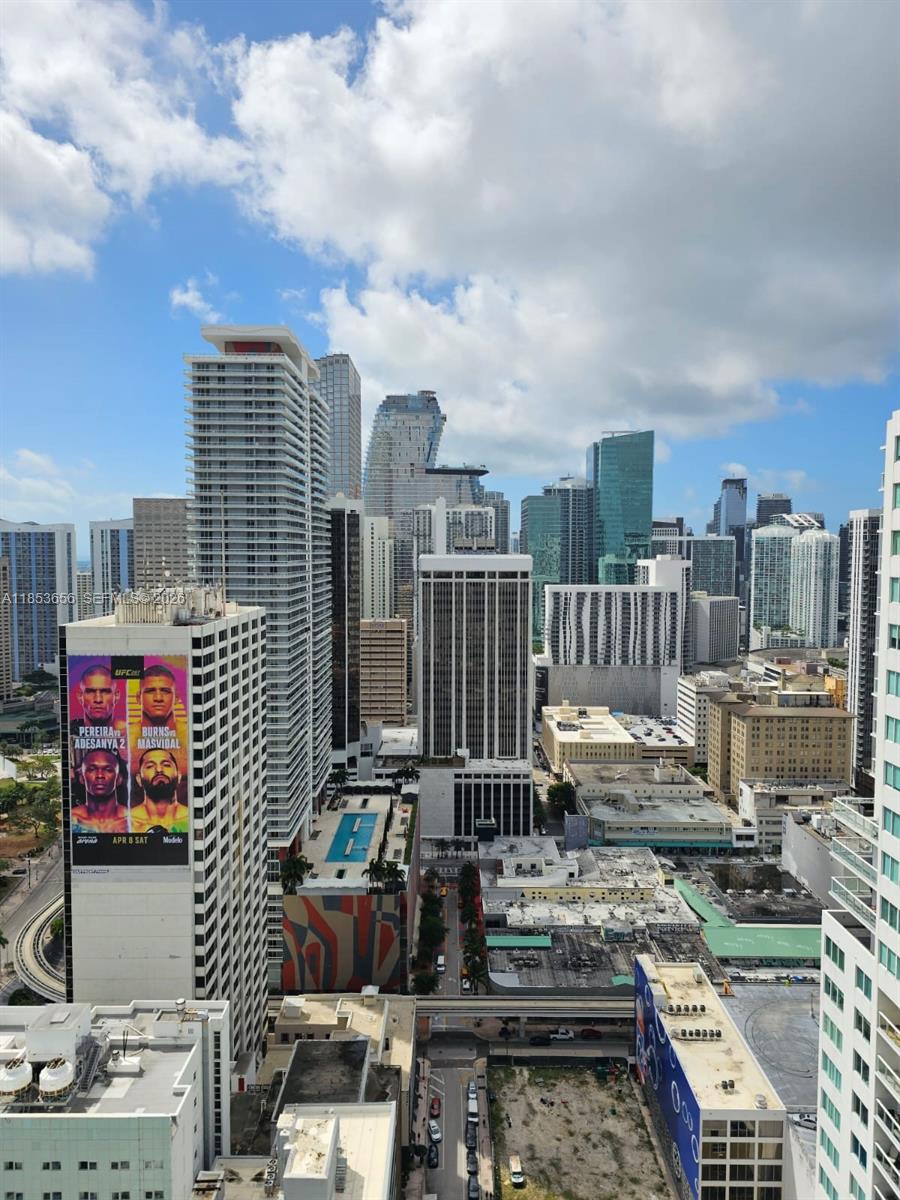 An elevated view of a dense urban skyline featuring numerous high-rise buildings under a cloudy sky — 244 Biscayne Blvd # 3707, Miami FL 33132, MIAMI, FL