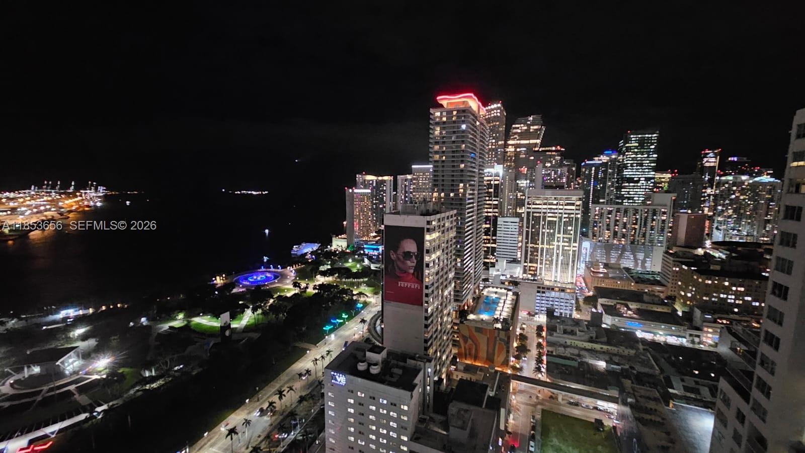 This night view shows a high-rise perspective of the Miami skyline and waterfront — 244 Biscayne Blvd # 3707, Miami FL 33132, MIAMI, FL
