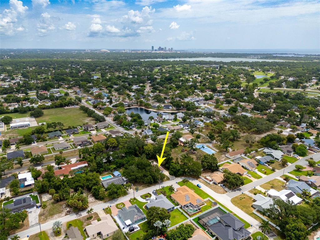 An aerial view shows a residential neighborhood with a yellow arrow pointing to a house — 2801 51ST AVENUE S, ST PETERSBURG, FL